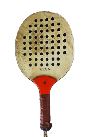 Original wooden padel racket on court surface showing early padel equipment design