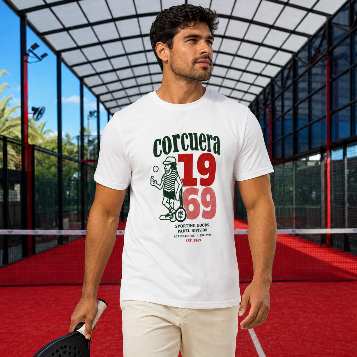 Lifestyle product image of the Corcuera 1969 white T-shirt worn by an Argentinian padel player on a covered red padel court.